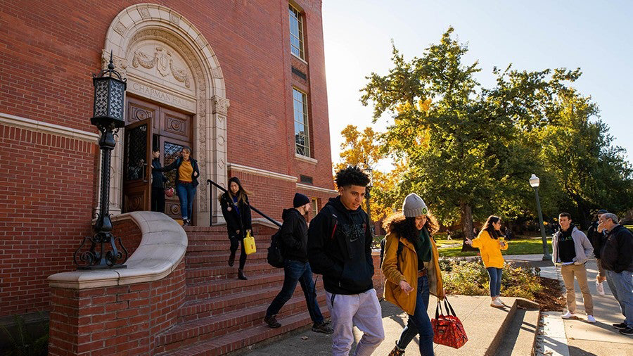 Students walking out the front doors of Chapman Hall