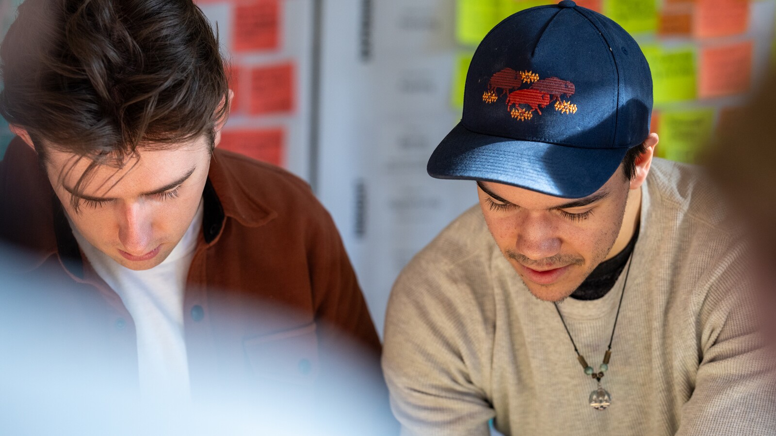 Two students looking down at a table