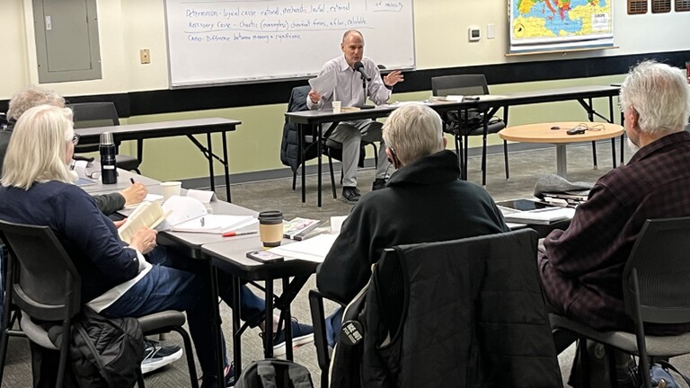 Adult learners attend a classroom seminar.