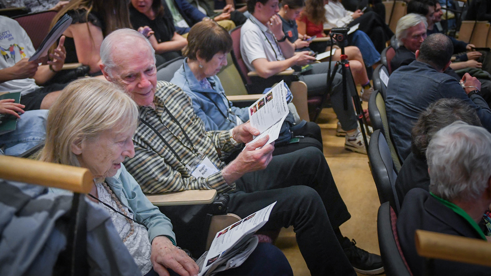 two senior citizens attending a Three Minute Thesis Competition