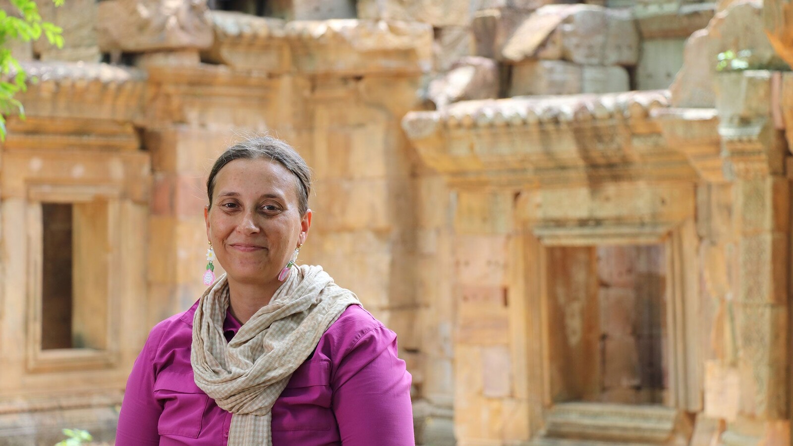 Anthropology professor Alison Carter stands at an archaeological site in Cambodia.