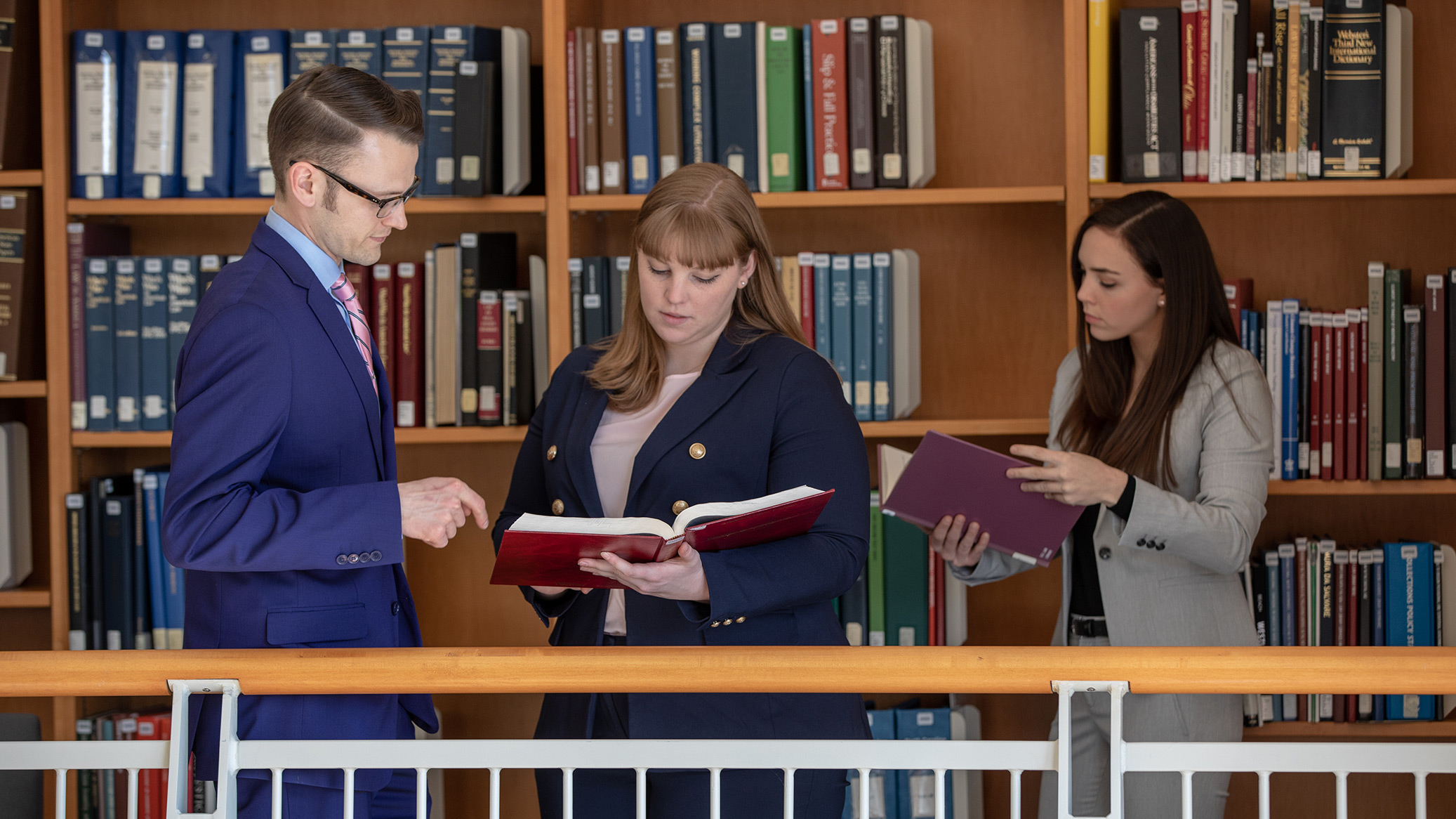 3 students in the Law library