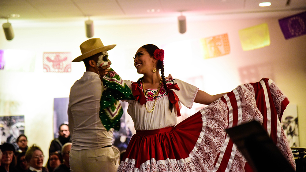 Two Latin dancers dancing with eachother