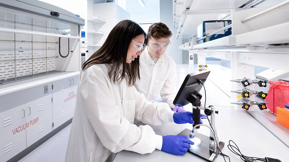 Two students looking at a screen in a lab