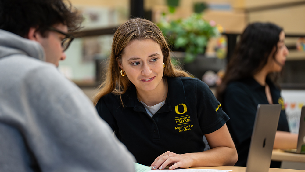 A student talking to a student employee in the Mohr Career Center