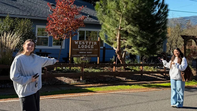 Two students standing in front of the Westfir Lodge