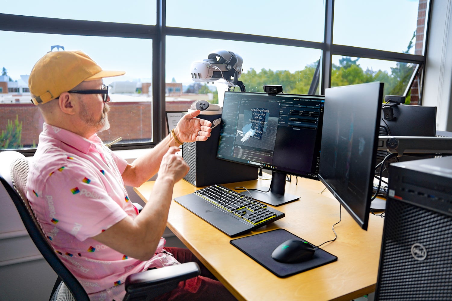 A man using his hands to control a computer, without a mouse or keyboard
