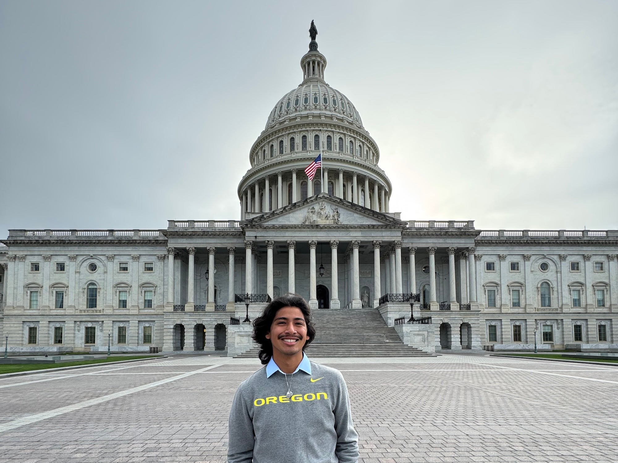 A law student standing in front of the capitol building in Washington DC