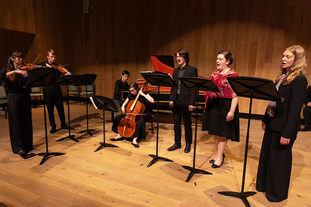 Students singing and playing instruments in a studio