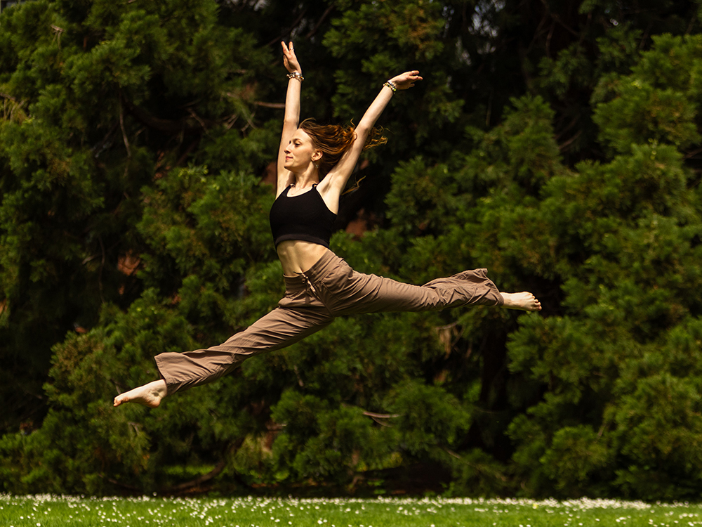 A dancer jumping outside