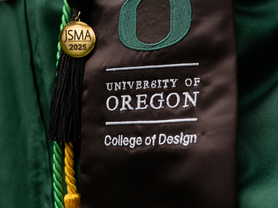 graduate wearing a College of Design sash