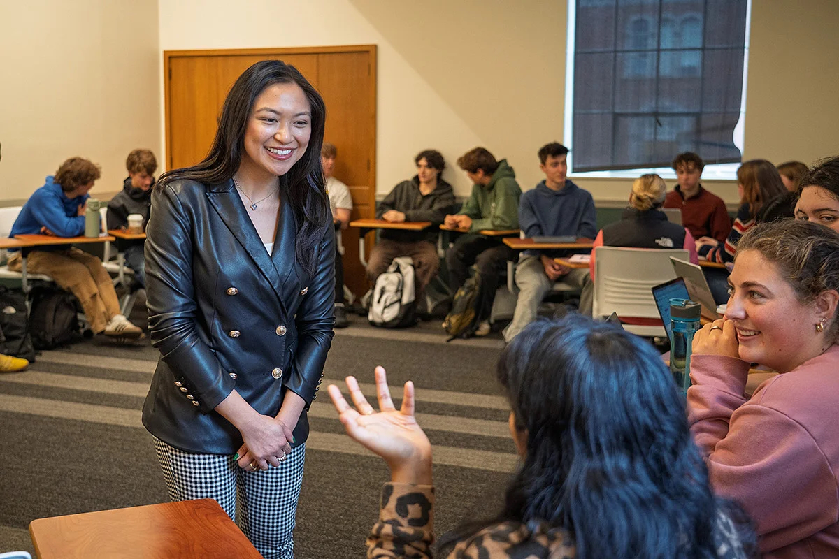 Lorie Acio smiling at students in a classroom