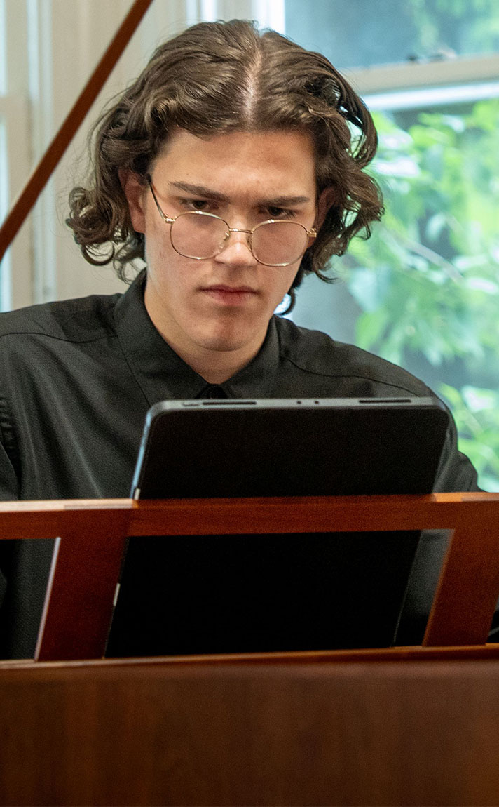 Nikita Istratov practices on the piano