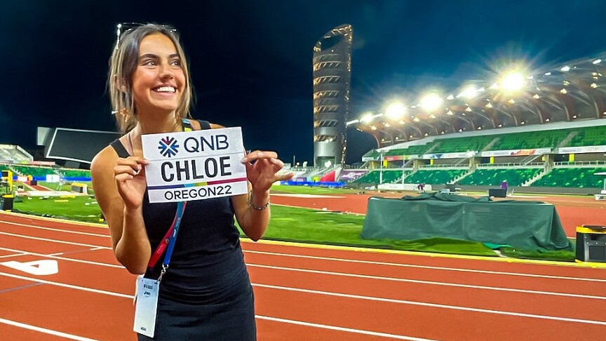 Chloe Montague holds a media credential at Hayward Field.