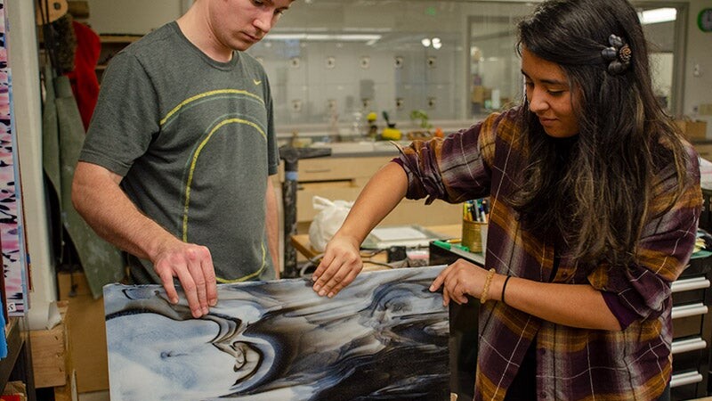 Students work together on an art project.