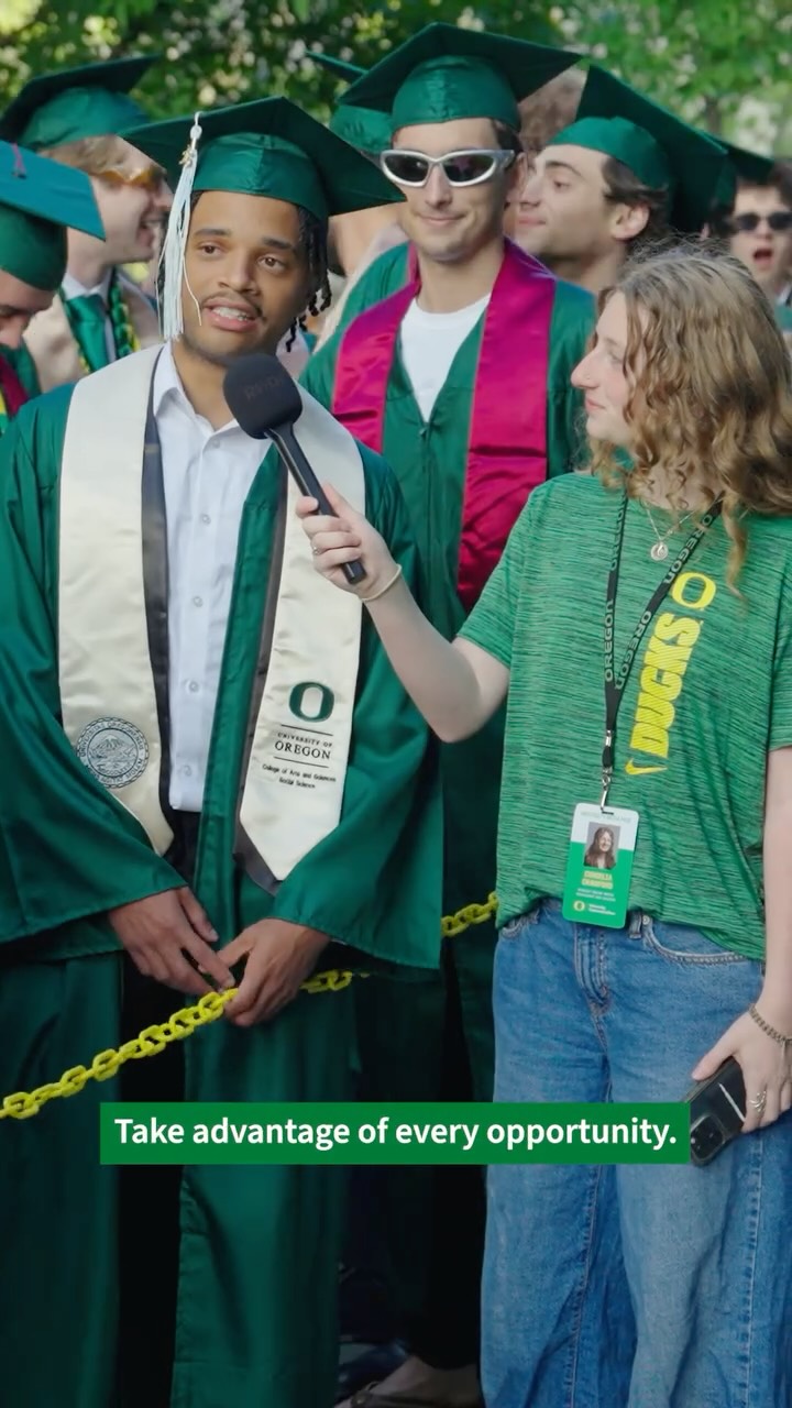 A graduating Duck is interviewed at commencement.