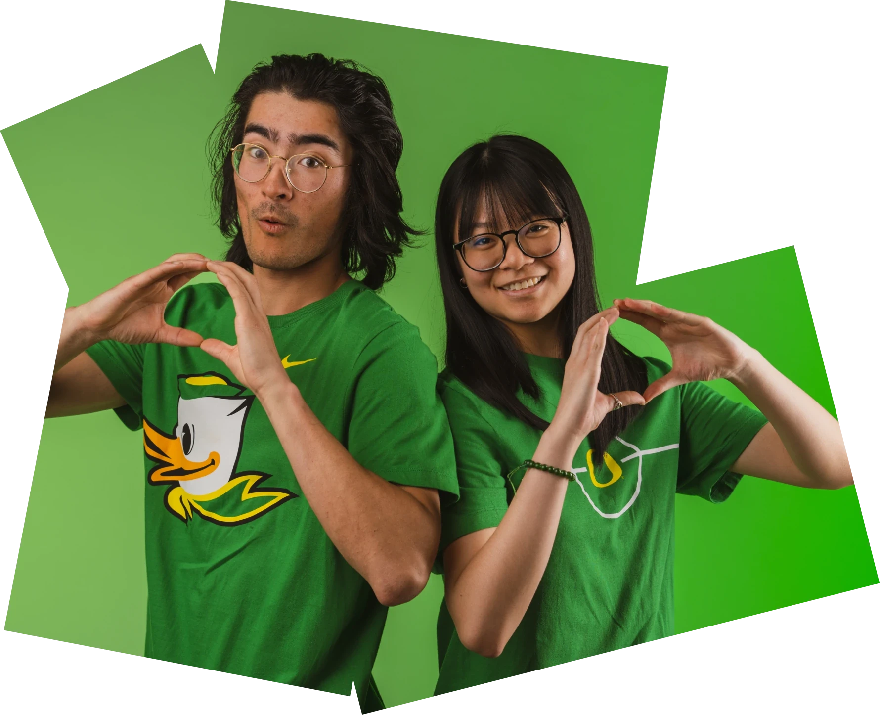 Two students in Oregon shirts make O shapes with their hands.