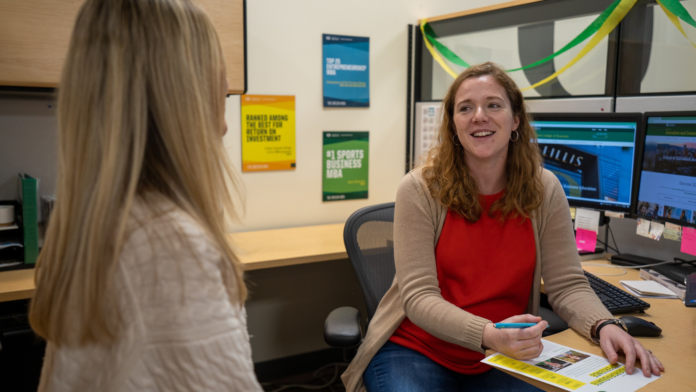An admissions counselor talks with a prospective student.