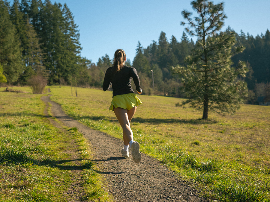 student jogging on running path