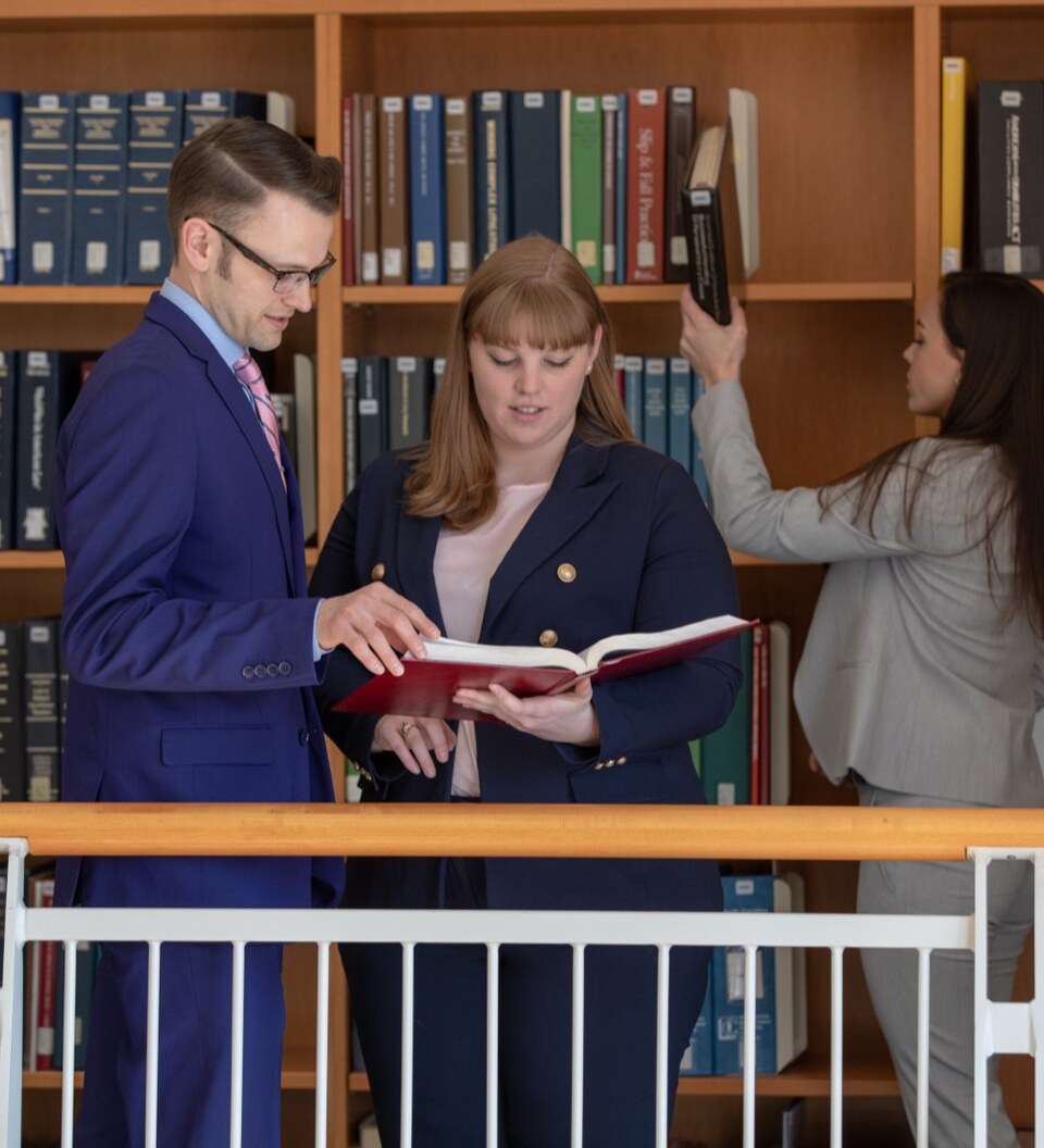 Law students study together in the library.