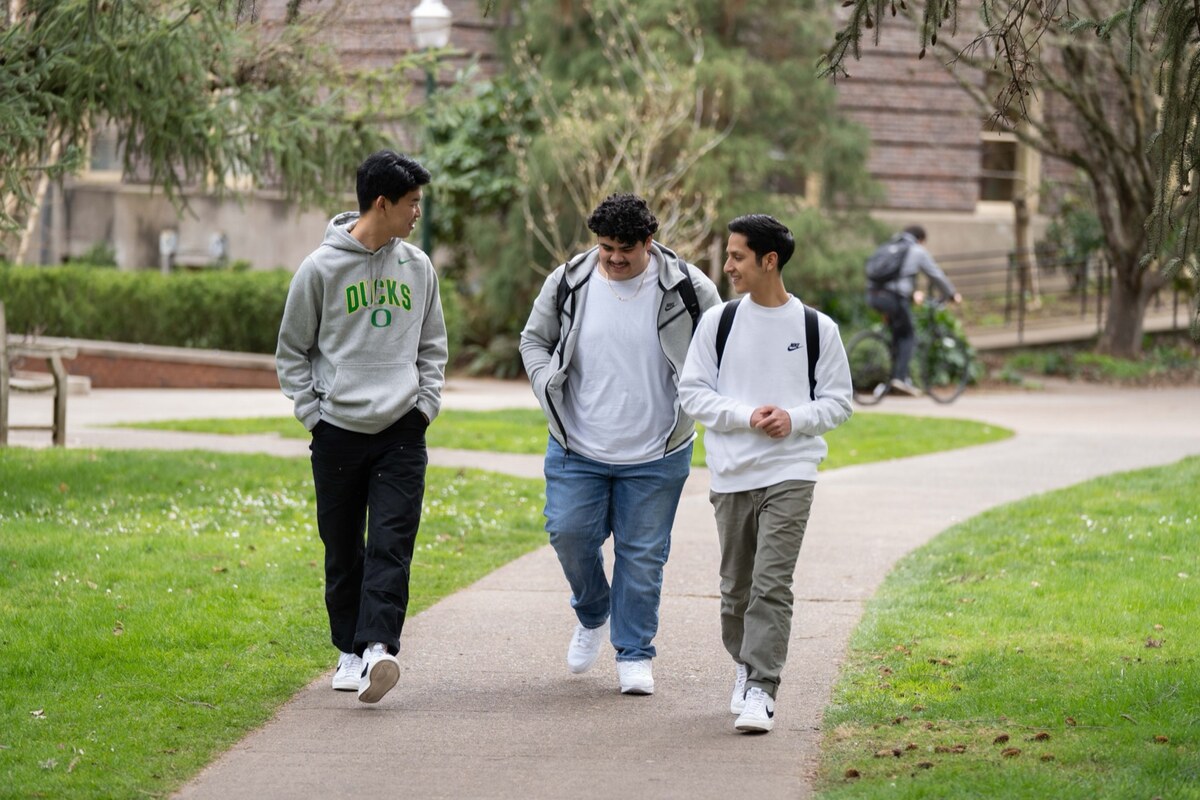 Students walk between campus buildings.