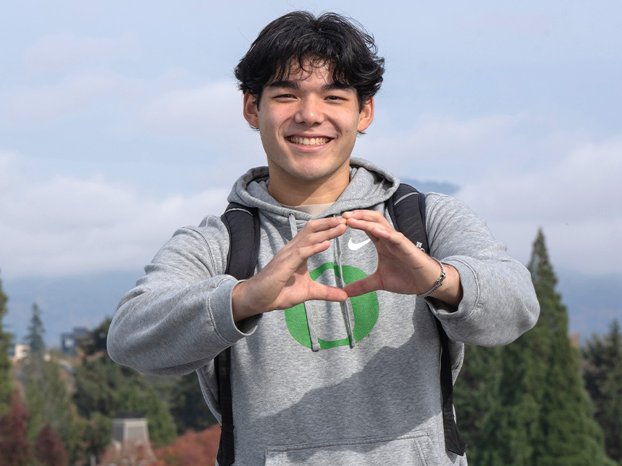 transfer student makes the "Throw Your O" symbol with his hands