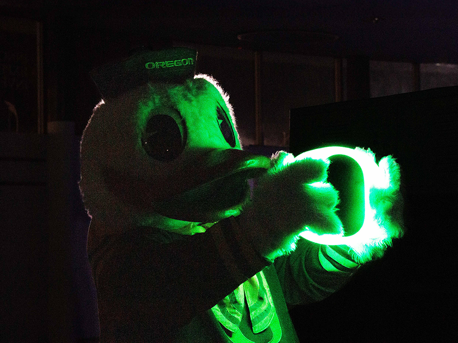 The Duck holding a neon O sign