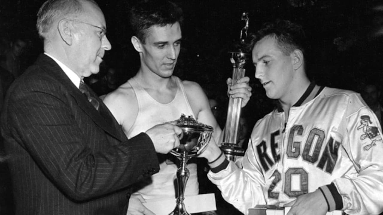 Oregon men's basketball players being handed a trophy in 1939