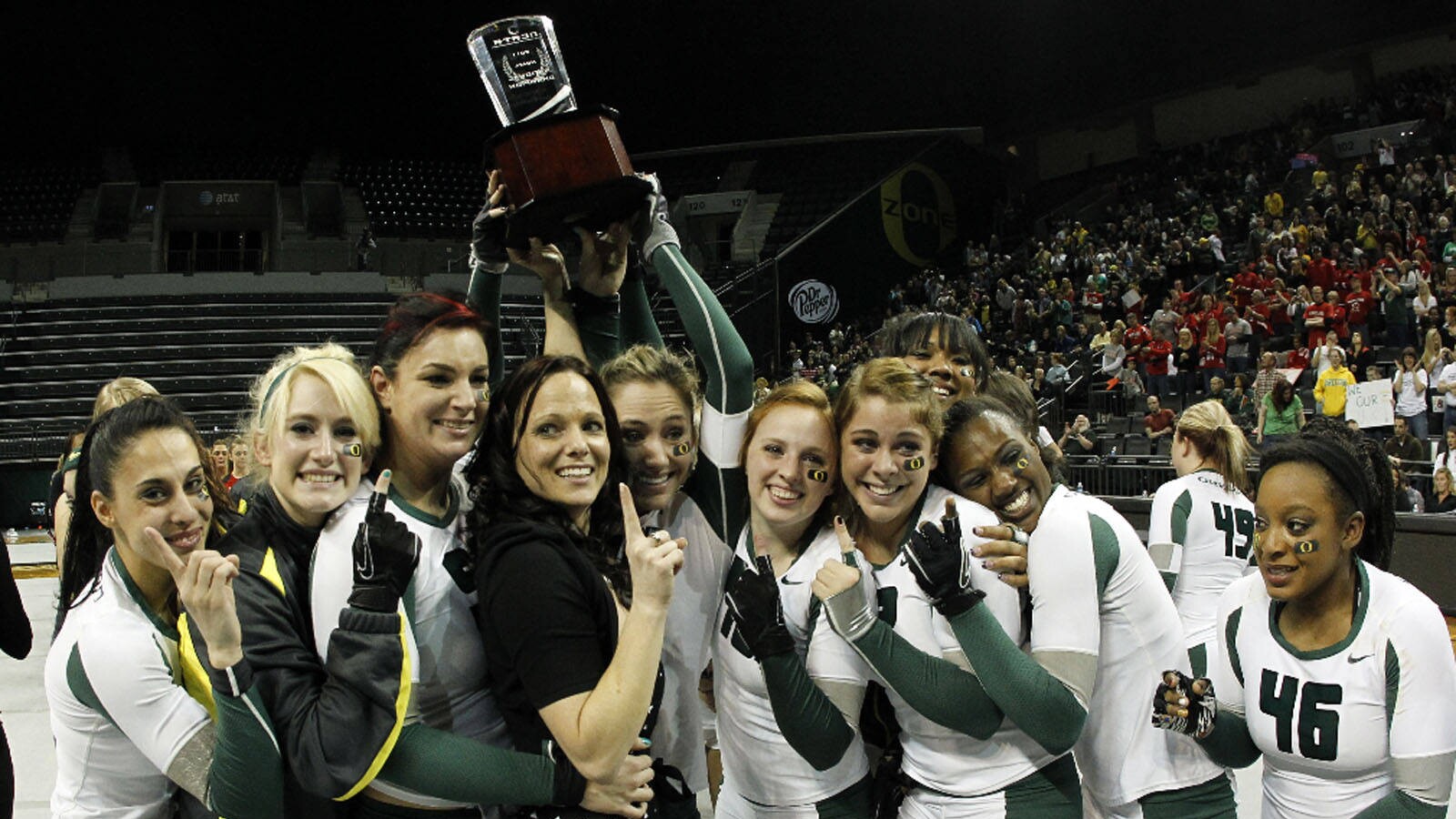 Oregon’s acrobatics and tumbling team celebrates with a trophy.