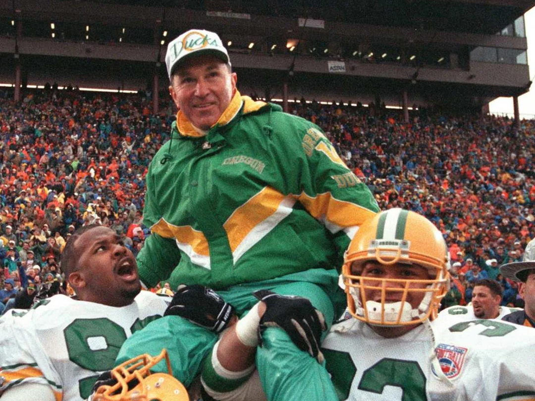 Historic photo of Rich Brooks being hoisted on top of football players shoulders