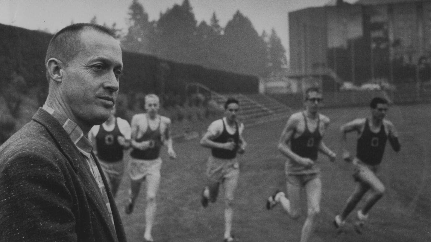Bill Bowerman watches runners during track practice.