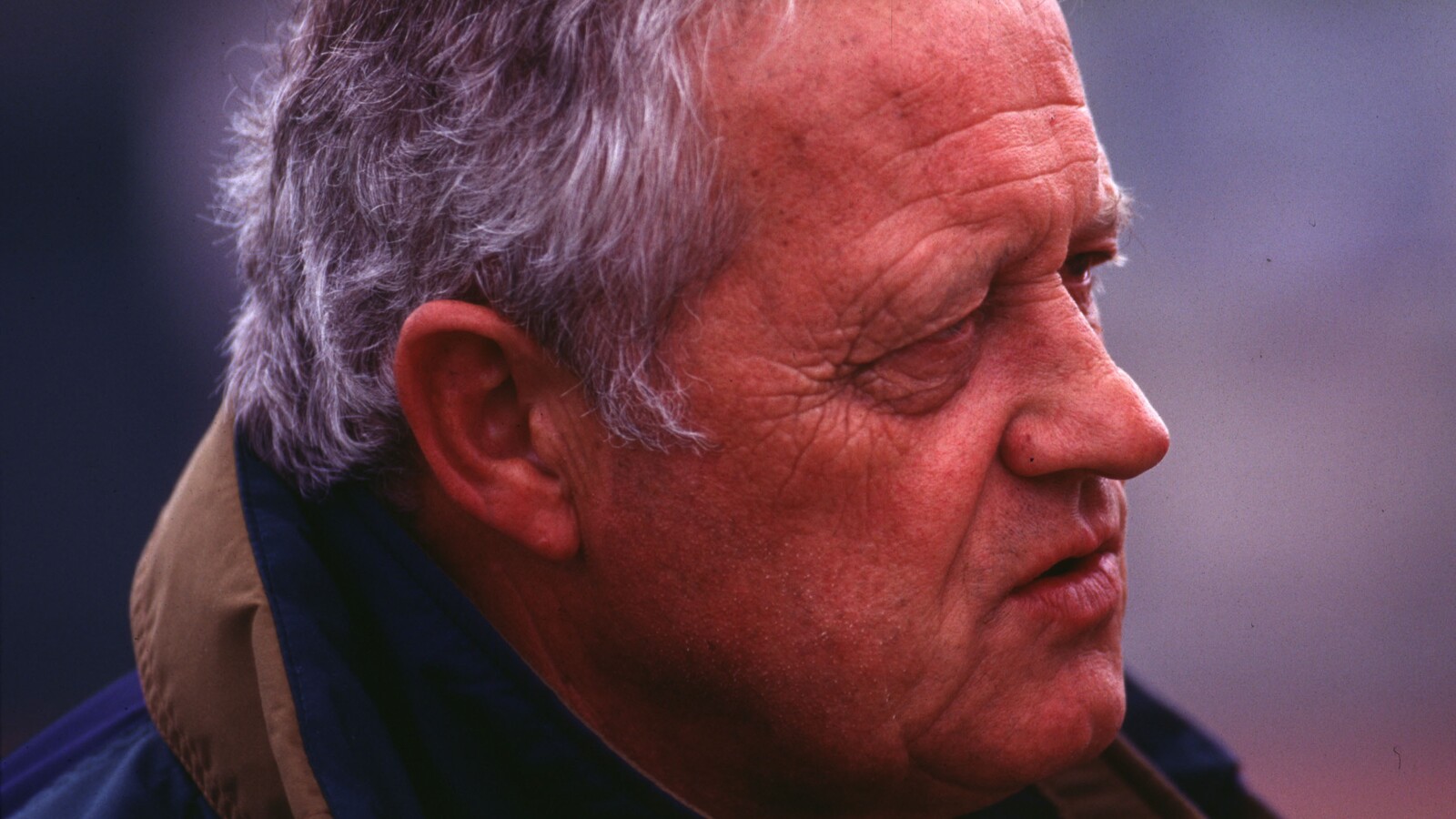 Bill Dellinger watches from the sideline.