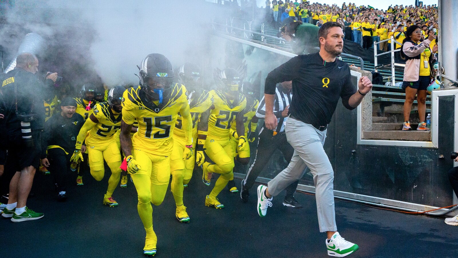 Oregon football coach Dan Lanning leads the team onto the Autzen Stadium field.