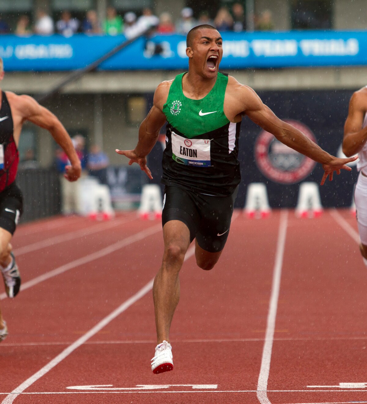 Ashton Eaton running across a finish line on a track