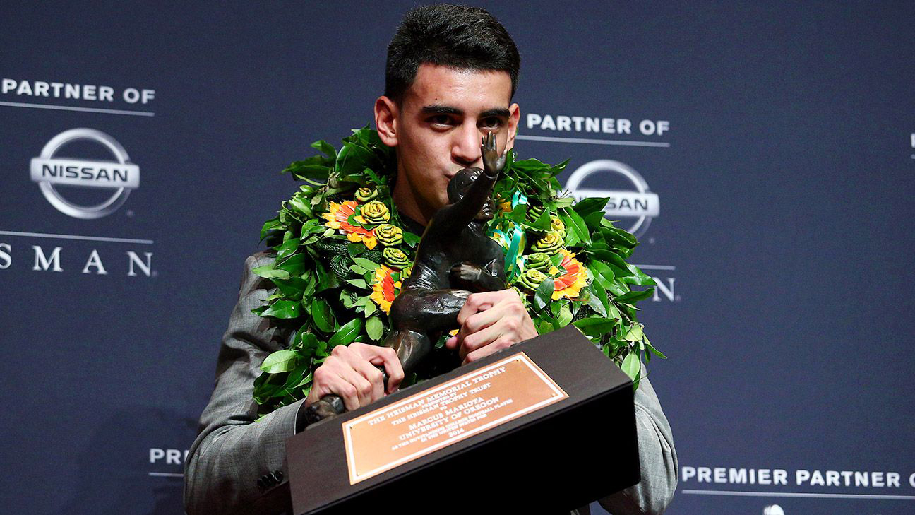 Marcus Mariota kissing the Heisman Trophy