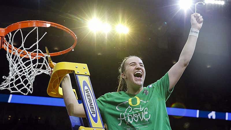 Sabrina Ionescu cutting down a basketball net