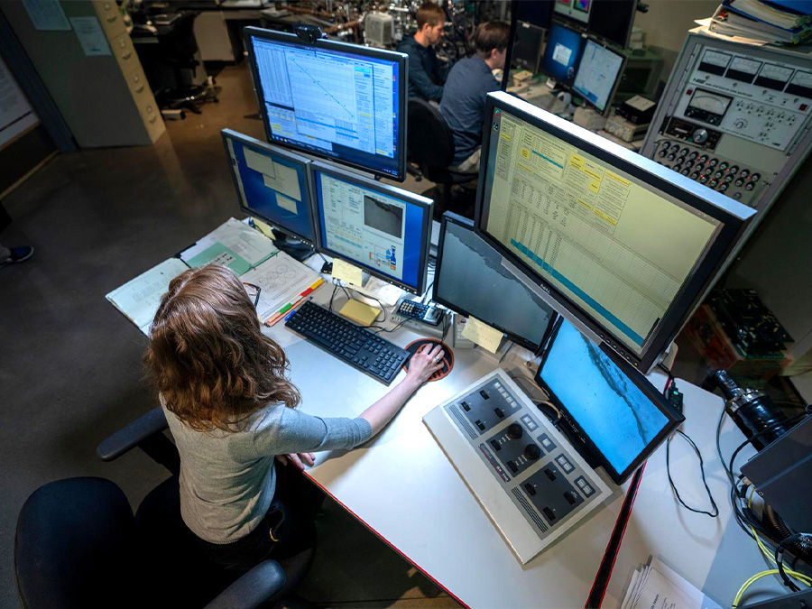 researcher working on multiple monitors