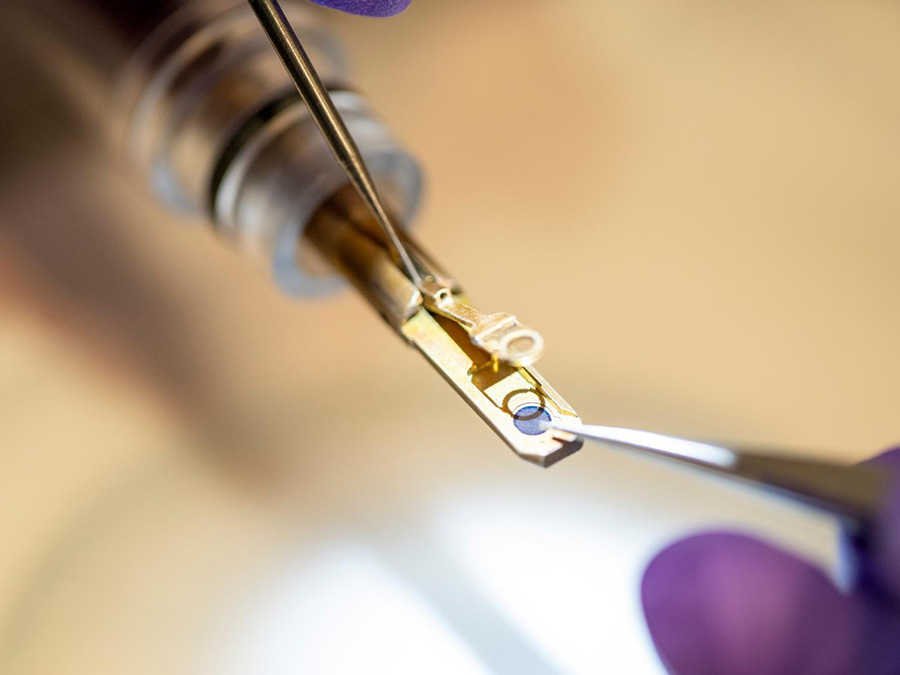 Close up shot of hand with tools working on electronics