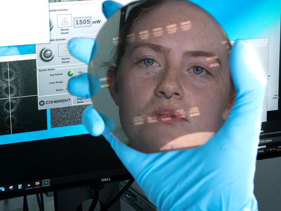 researcher looking at reflective disc