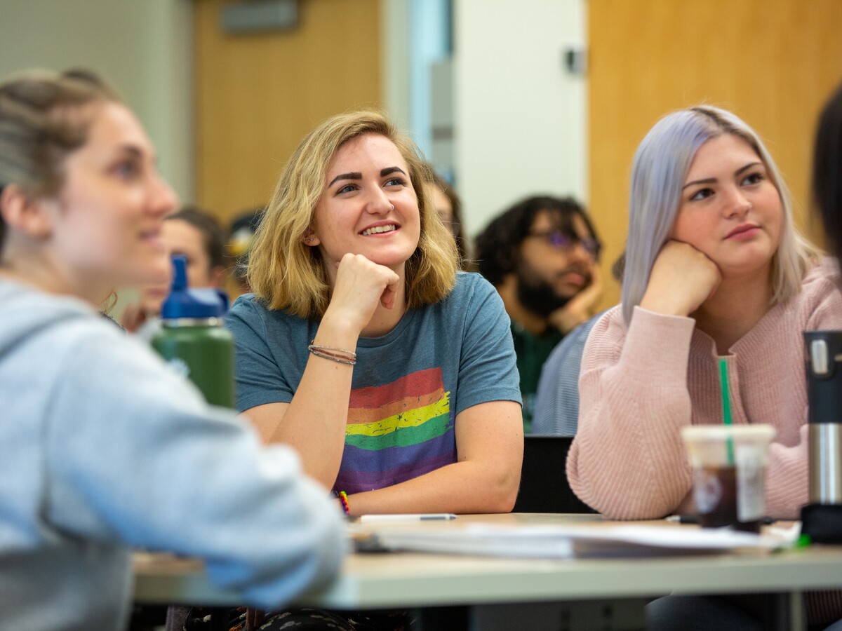 Students watch an instructor during an ASL class.