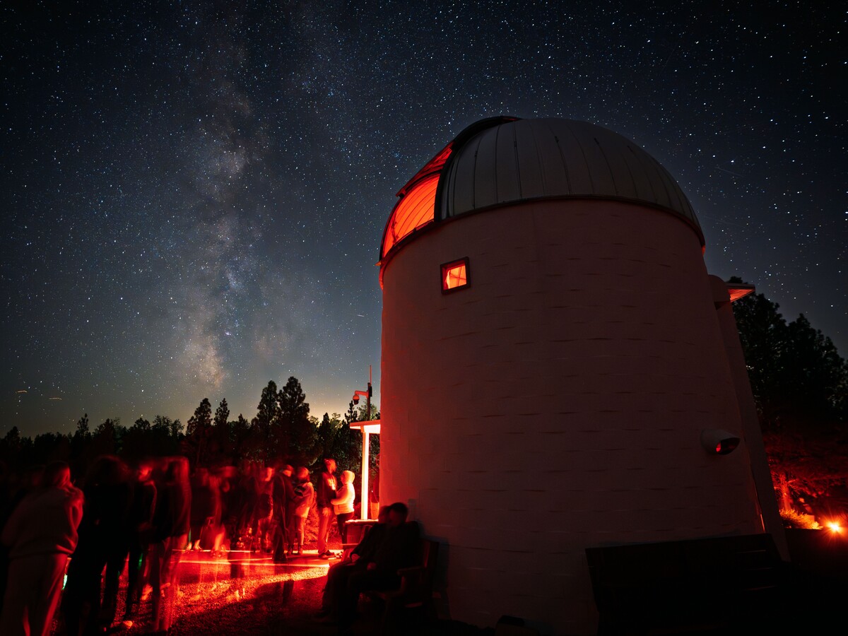 Visitors gather outside Pine Mountain Observatory beneath the Milky Way.