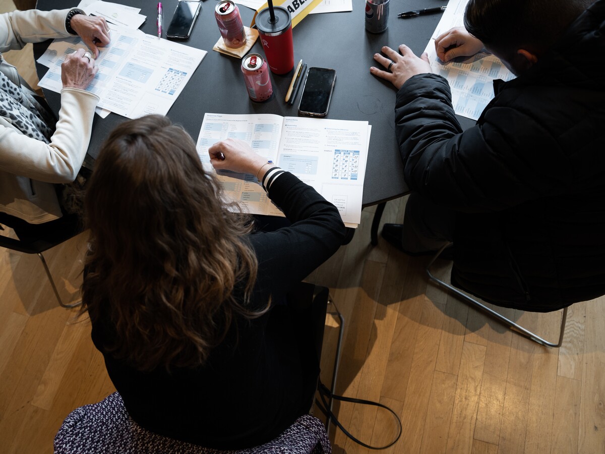 Conference participants work together around a table.