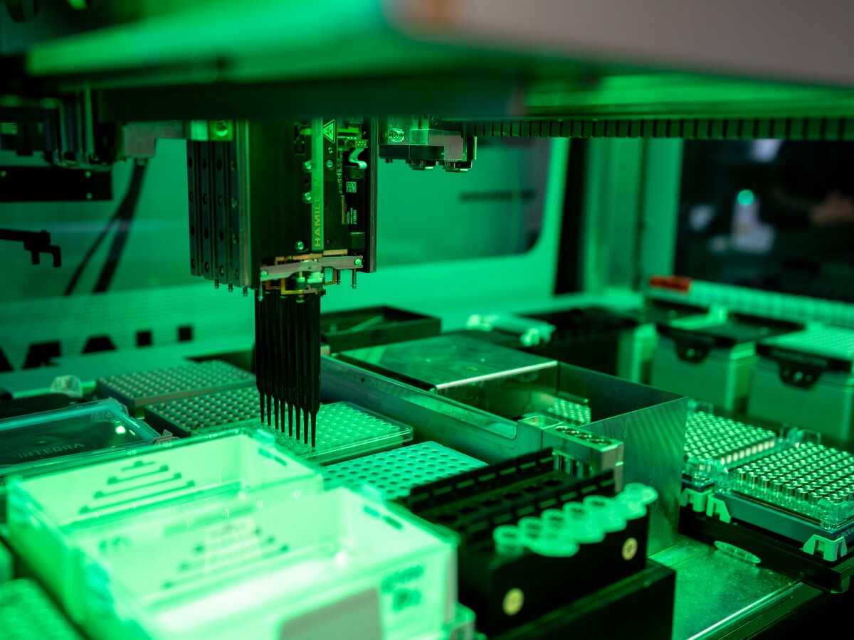 Automated pipettes process samples in the genomics core facility.
