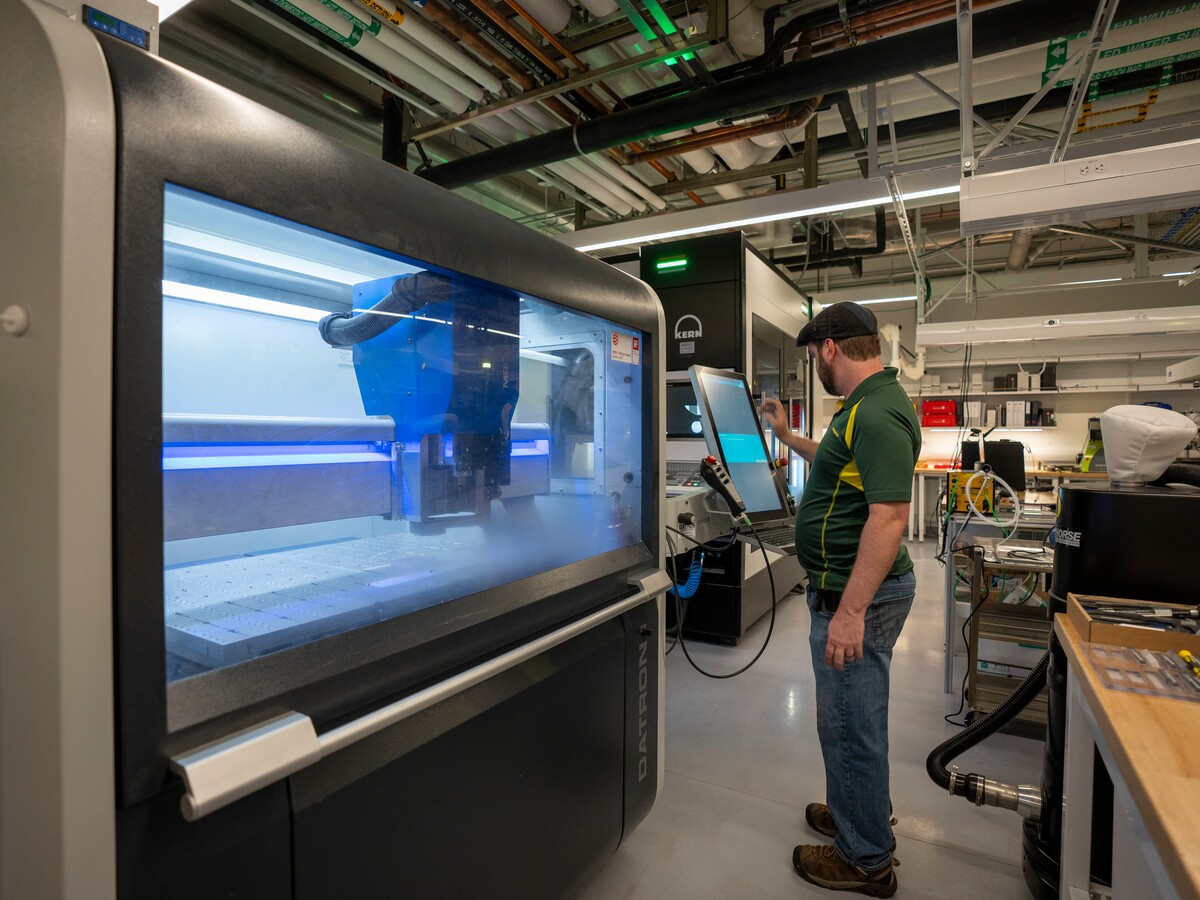 A person operates fabrication equipment in the Oregon Fabrication and Design facility.