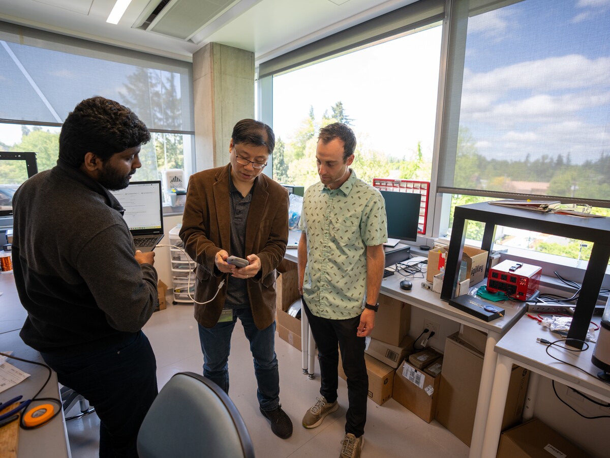 Researchers and partners review a prototype in a University of Oregon laboratory.