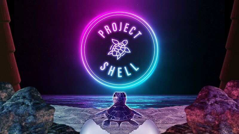 A sea turtle faces the glowing Project Shell logo in a virtual-reality scene.
