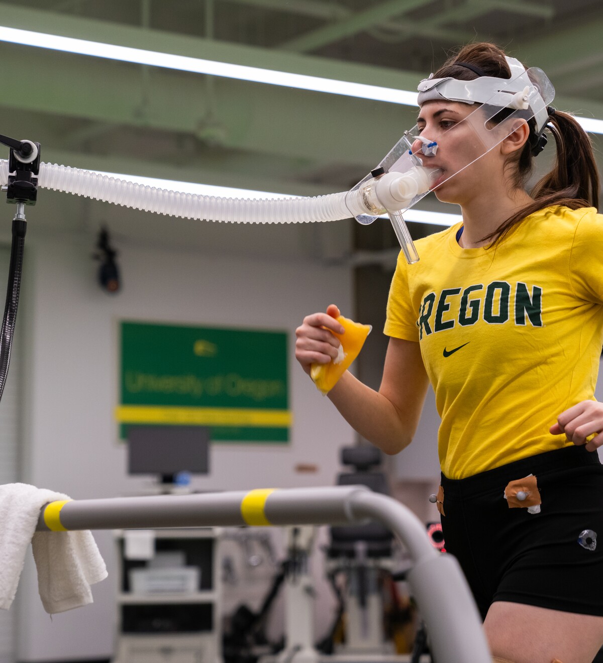 A runner completes a treadmill test while wearing breathing equipment.