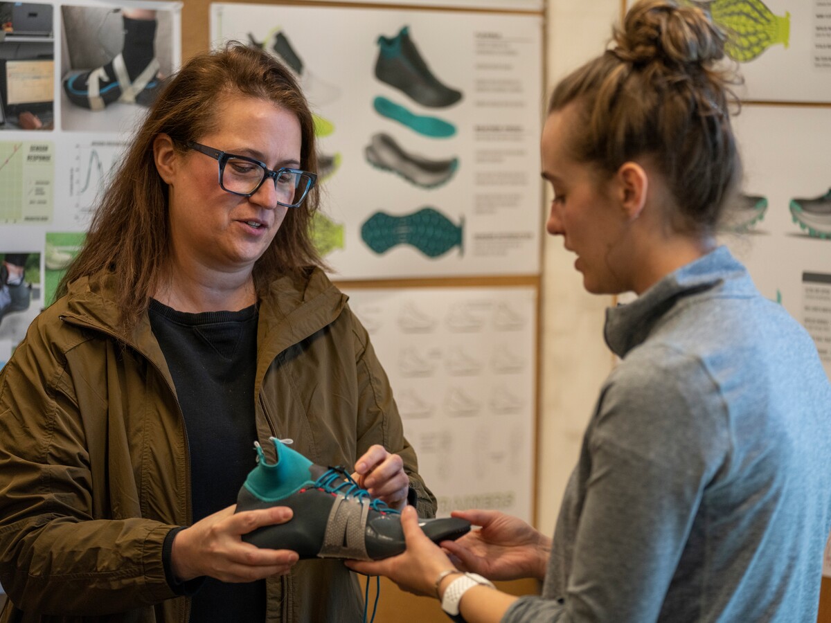 Two designers discuss an athletic shoe prototype.