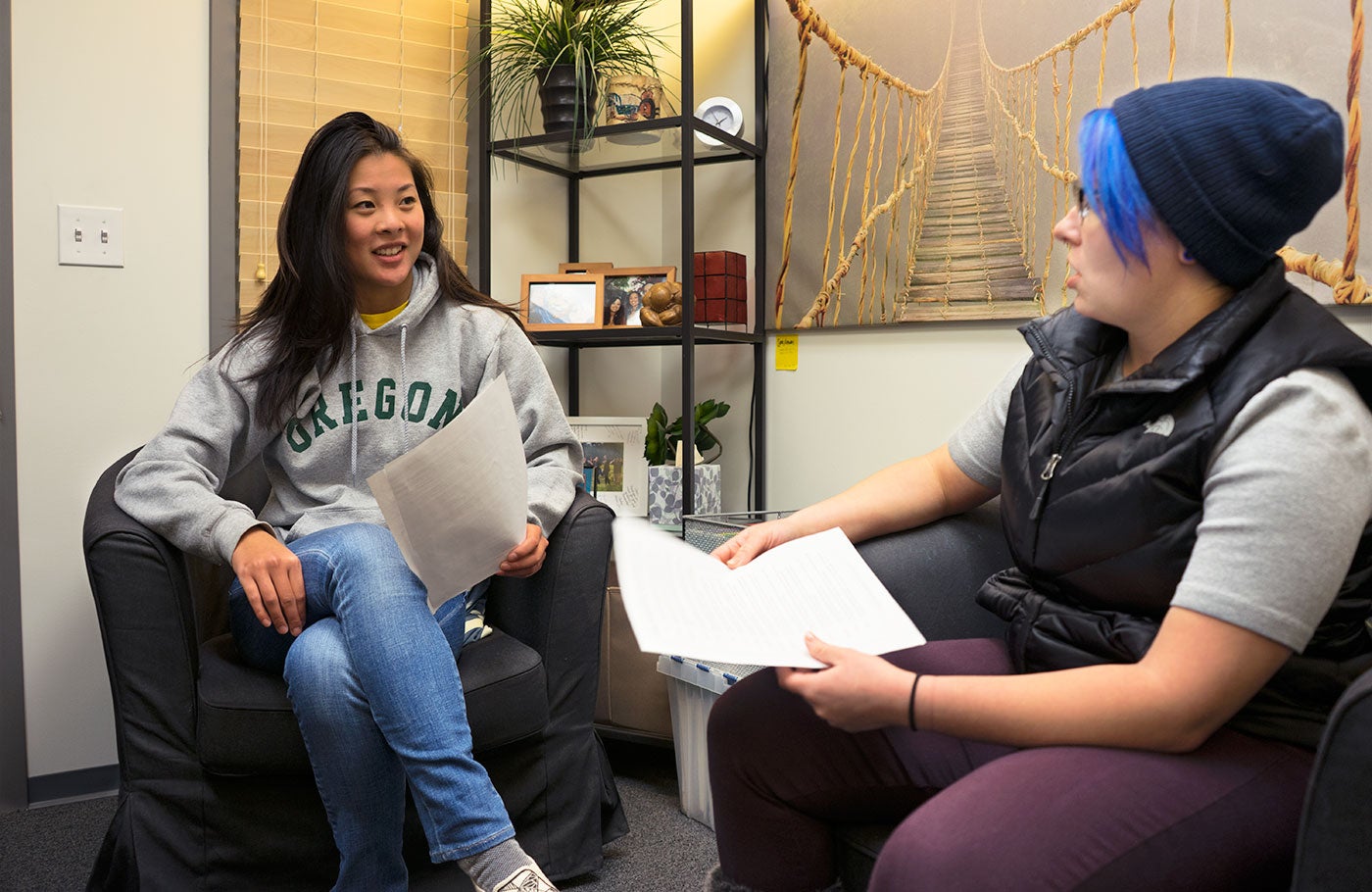 Student sitting next to an advisor talking