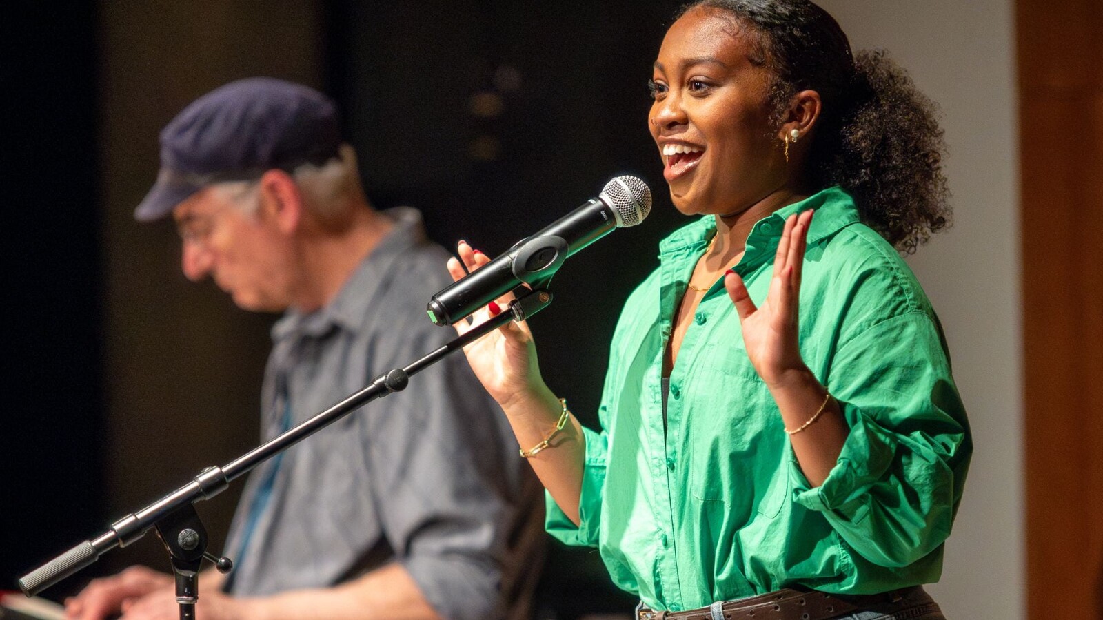 A speaker shares a story during an Intertwined performance.